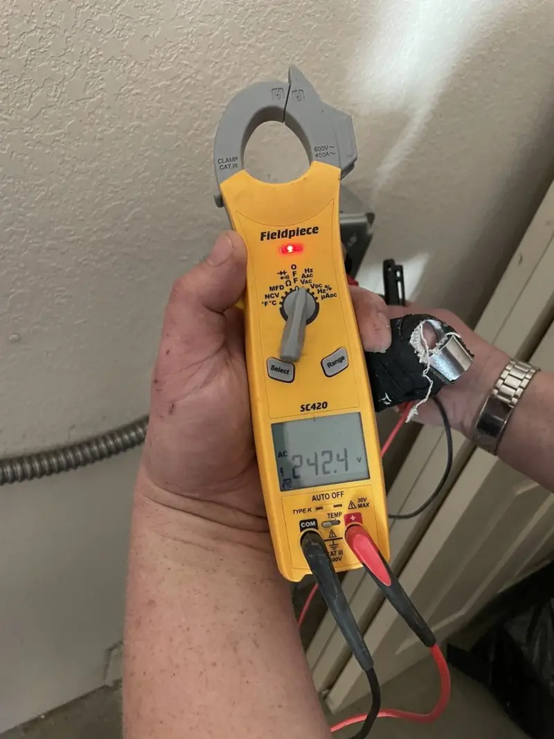 Voltage testing with clamp meter during Whole House Surge Protector in Fairburn